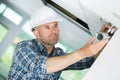 Technician adjusting cctv camera on wall Royalty Free Stock Photo