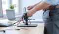 Technician Adjusting Electronic Device with Wires on Desk Royalty Free Stock Photo