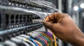 Technician adjusting network cables in a medium shot demonstrating handson management of content delivery networks Royalty Free Stock Photo