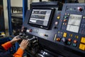 Technician adjusting settings on the CNC machine Royalty Free Stock Photo