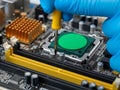 Technician Assembling Computer Motherboard with Yellow Screwdriver Royalty Free Stock Photo