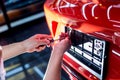 Technician changing car plate number in service center.