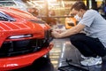 Technician changing car plate number in service center.