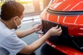 Technician changing car plate number in service center.