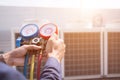 Technician vacuum pump evacuates and checking new air conditioner. Royalty Free Stock Photo