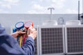 Technician is checking air conditioner ,measuring equipment for filling air conditioners Royalty Free Stock Photo