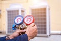 Technician vacuum pump evacuates and checking new air conditioner. Royalty Free Stock Photo