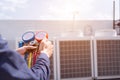 Technician vacuum pump evacuates and checking new air conditioner. Royalty Free Stock Photo