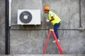 Technician checking air conditioner