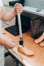 Technician checking artificial limb while at desk in workshop, adjusting it and checking for quality Royalty Free Stock Photo