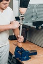 Technician checking artificial limb while at desk in workshop, adjusting it and checking for quality Royalty Free Stock Photo