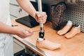 Technician checking artificial limb while at desk in workshop, adjusting it and checking for quality Royalty Free Stock Photo