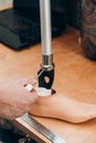 Technician checking artificial limb while at desk in workshop, adjusting it and checking for quality Royalty Free Stock Photo