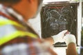 Technician checking electrical switch board on fire short circuit