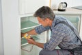 Technician Checking Fridge With Digital Multimeter Royalty Free Stock Photo