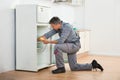 Technician Checking Fridge With Digital Multimeter Royalty Free Stock Photo