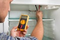 Technician Checking Fridge With Multimeter Royalty Free Stock Photo