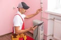 The technician checking the heating system with tablet in hand Royalty Free Stock Photo