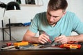 Technician checking mobile phone in repair shop Royalty Free Stock Photo