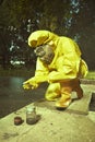 Technician in chemical protective suit controlling water contamination Royalty Free Stock Photo