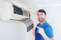 Technician cleaning air conditioner filter on the wall at home for hvac service Royalty Free Stock Photo