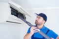 Technician cleaning air conditioner filter on the wall at home for hvac service Royalty Free Stock Photo