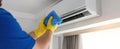 The technician cleaning an air-conditioning unit for optimal performance..AI generated image Royalty Free Stock Photo