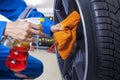 Technician cleaning a tire at workshop