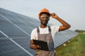Technician with clipboard doing inspection of solar panels Royalty Free Stock Photo