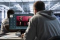 Technician coding AI virtual assistant producing clips