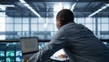 Technician coding on laptop in data center, managing server virtualization Royalty Free Stock Photo