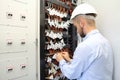 Technician in communications box connecting opto fibers Royalty Free Stock Photo