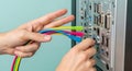 Technician Connecting Color-Coded Cables to Computer Back Panel for Data Transfer Royalty Free Stock Photo