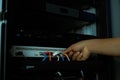 Technician connecting ethernet cables to network switch rack inside server room, representing data center infrastructure, secure Royalty Free Stock Photo