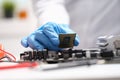 Technician connects a CPU microprocessor to motherboard socket