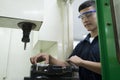 Technician controlling CNC machine.