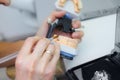 Technician dental is working with complete lower and upper metal ceramic prosthesis dental. Dental technician works by Royalty Free Stock Photo