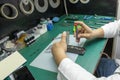 A technician disassembling a mobile phone in his small taller