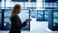 Technician doing yearly checkup using tablet to preserve data center electronics Royalty Free Stock Photo
