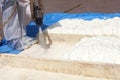 Technician dressed in a protective white uniform spraying foam i Royalty Free Stock Photo