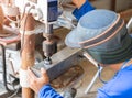 Technician drilling in Steel pipe with Bench Drill