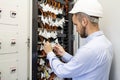 Technician engineer connects optical fibers into communication switch in data center. Service man in datacenter