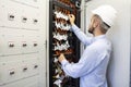 Technician engineer in datacenter. Network technician connecting fiber optic at server room.