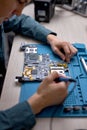 technician or Engineer installing CPU microprocessor to motherboard socket. top view Royalty Free Stock Photo