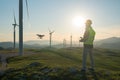 Technician Engineer in Wind Turbine Power Generator Station launches a drone for visual control of generators