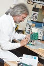 Technician engineer at work with microchip Royalty Free Stock Photo