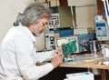 Technician engineer at work with microchip Royalty Free Stock Photo