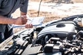 Technician engineer working of car mechanic in doing checklist for repairs engine writing to the clipboard repairing vehicle, Royalty Free Stock Photo