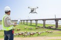 Technician farmer use computer control drone tracking the cow