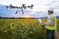 .Technician farmer use wifi computer control agriculture drone on the sunflower field, Smart farm concept Royalty Free Stock Photo